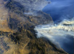 Image of A photo from the International Space Station shows smoke from the fires blowing out to sea. 