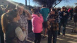 Image of Parents wait anxiously while Aztec High School is evacuated. At least two students died during the incident on Thursday. 